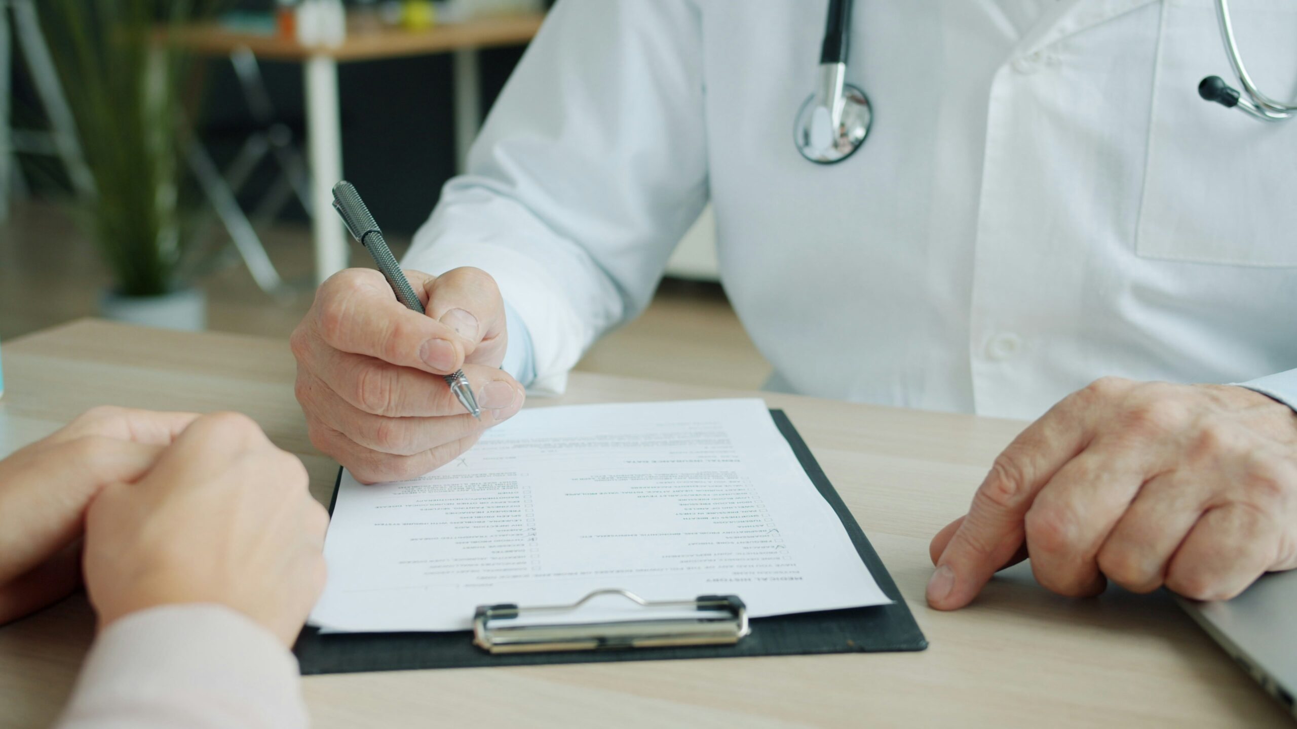 Consultant paediatrician reviewing hospital records and imaging for an independent report