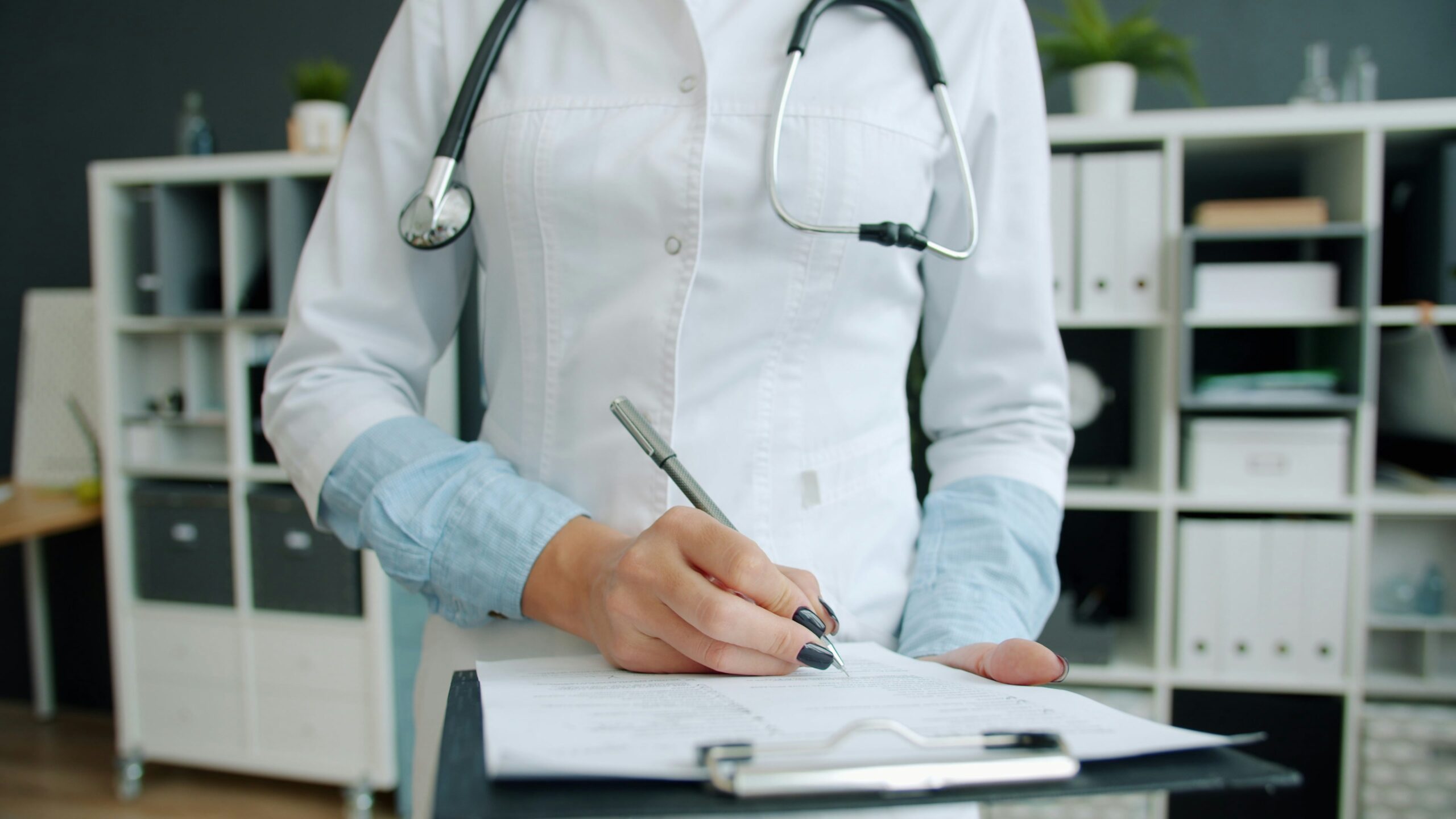 Consultant paediatrician reviewing clinical and developmental records for an independent report